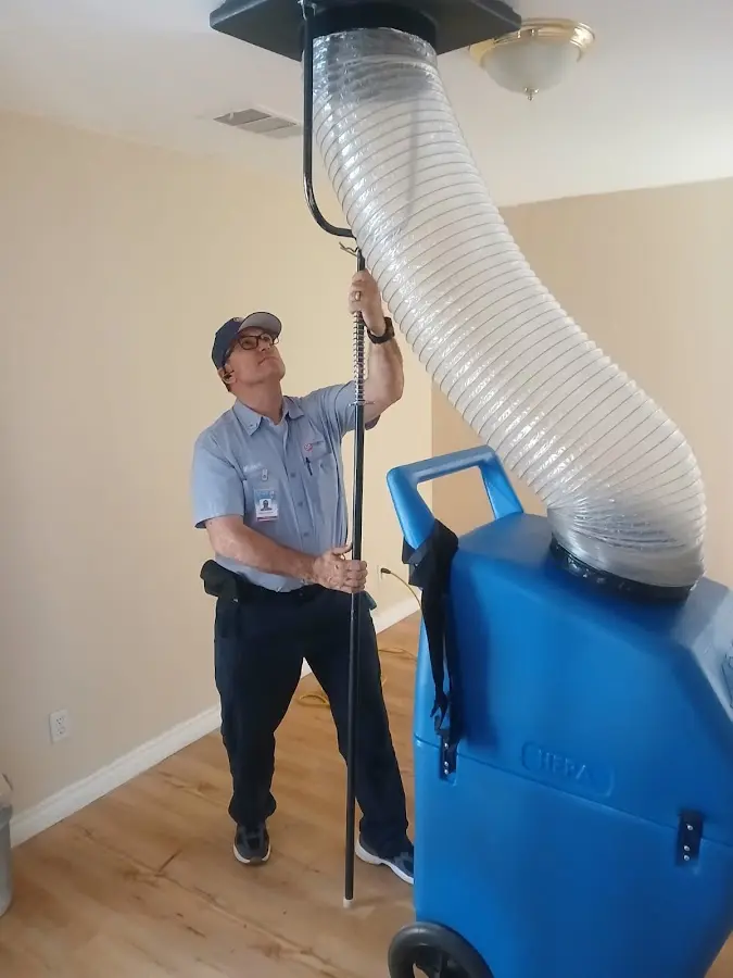 Furnace Tune-Up technician using HEPA equipment in Dripping Springs